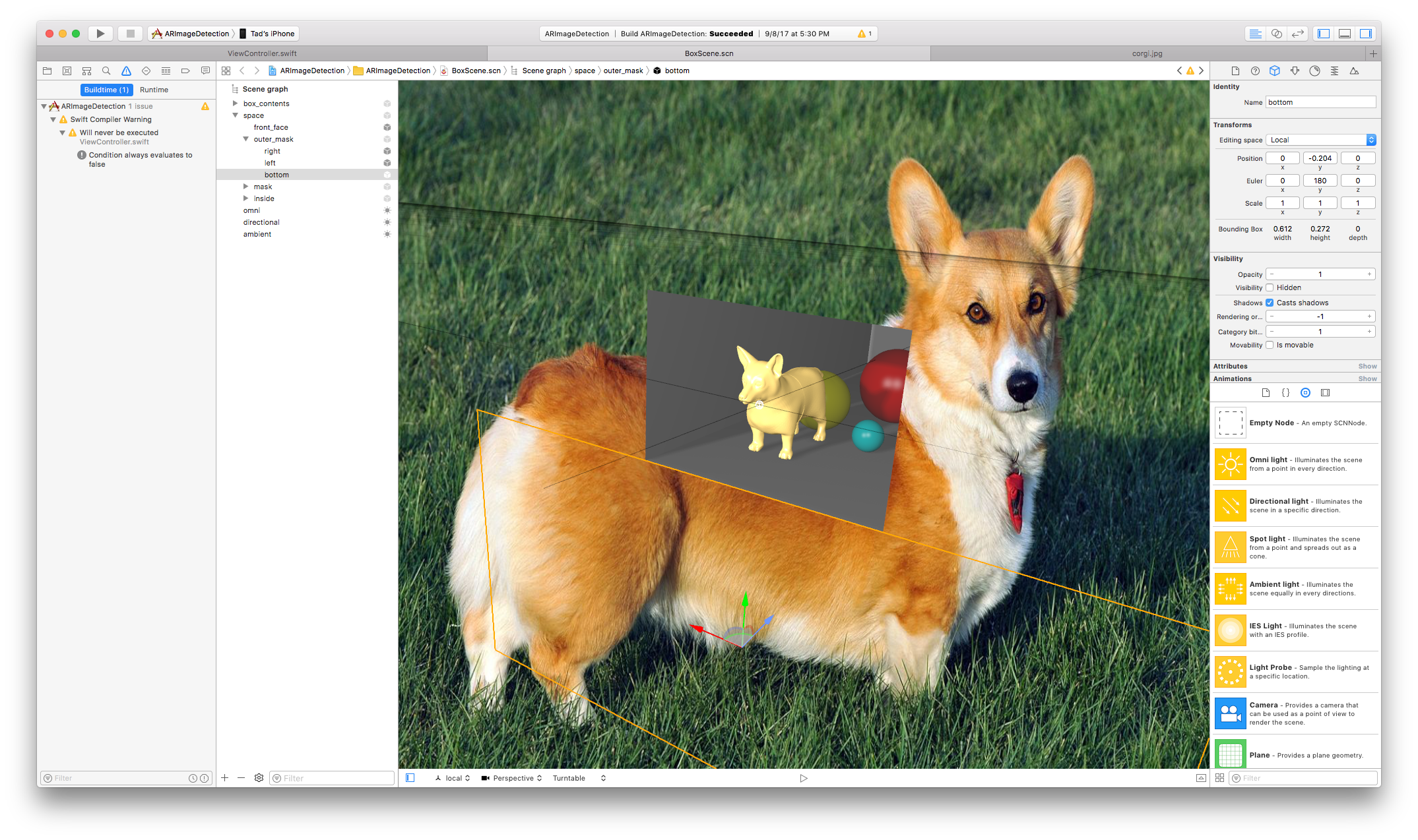 Xcode interface showing a 3D scene with a large image of a corgi and a box containing spheres and a model corgi